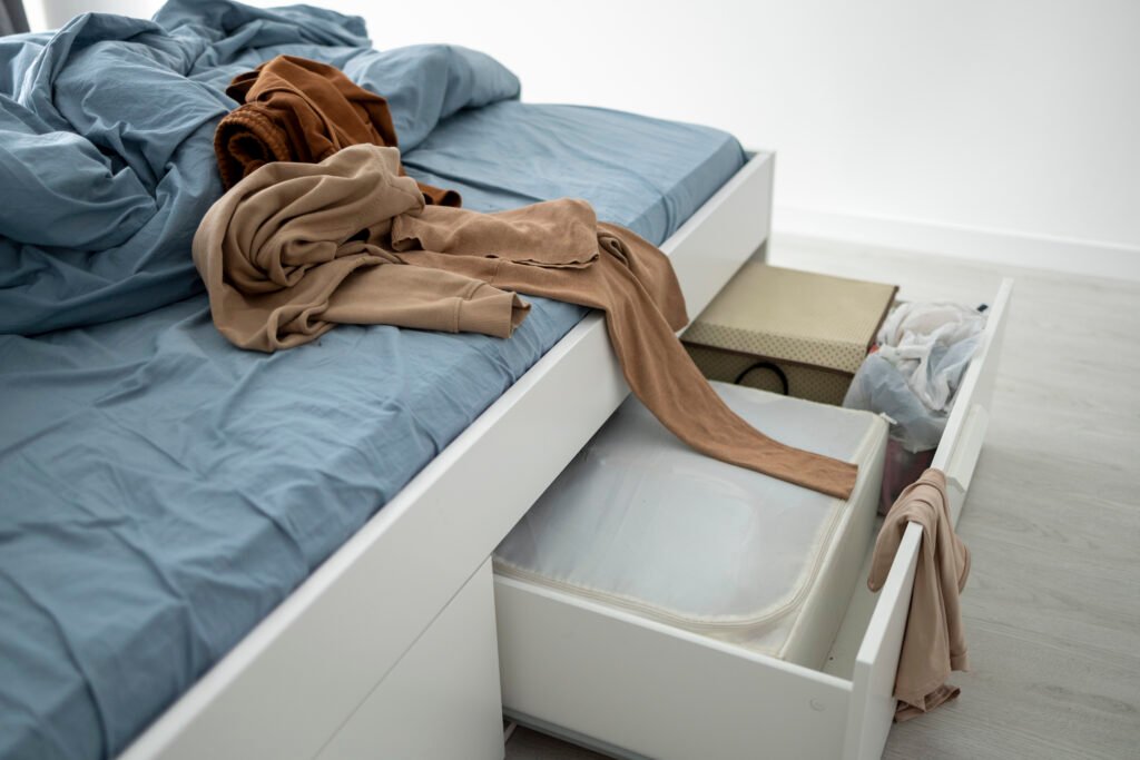 high-angle-messy-clothes-bed